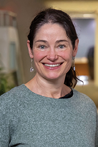 Close up of Sasha Brown, occupational audiologist at WorkSafeBC, standing in an office hallway.