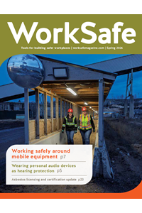 Cover with photo on semi-dark construction site with two workers wearomg hi-vis clothing and hard hats.